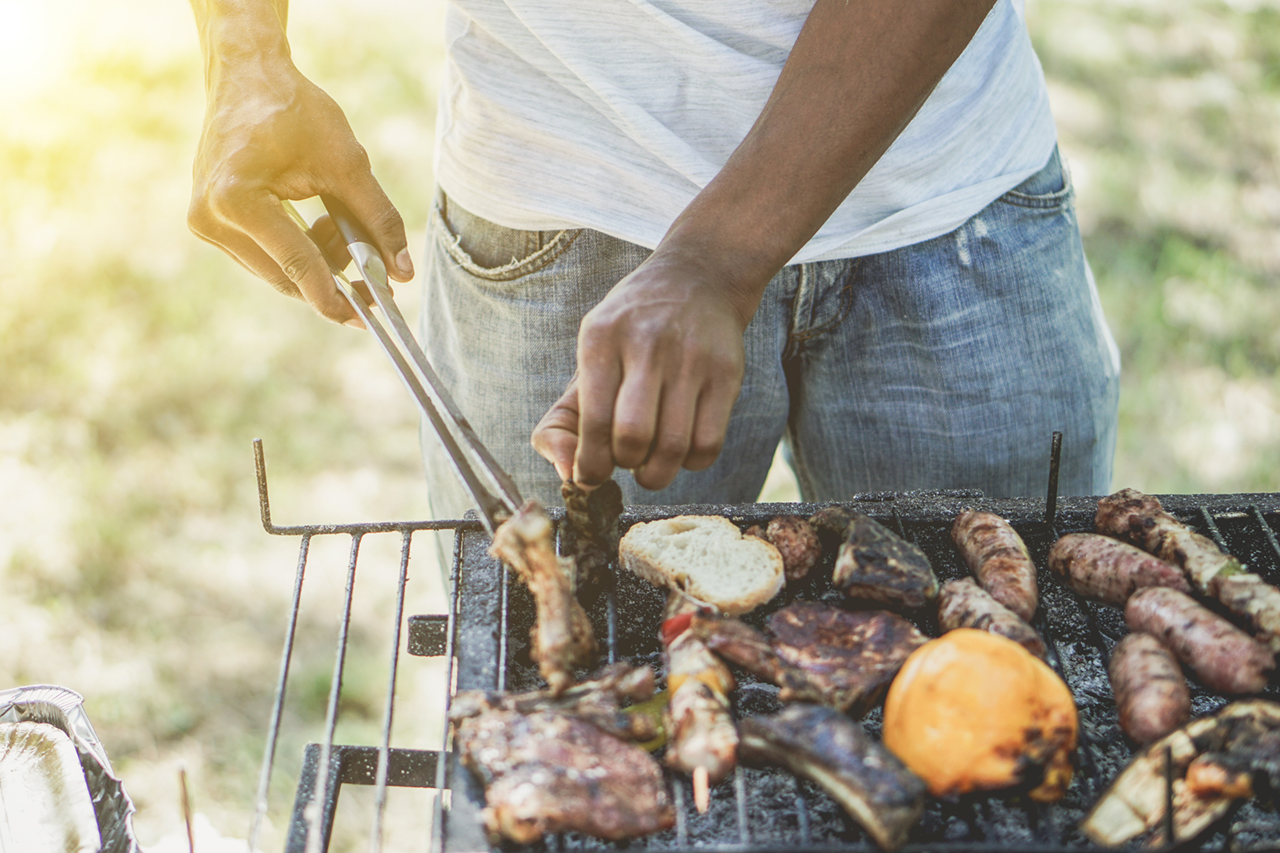 man grilling out back